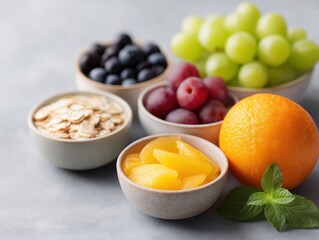 Fresh Fruit and Oats in Bowls with Green Grapes, Blueberries, Grapes, and Orange