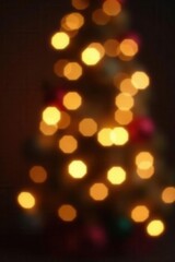 Obraz premium Dark bokeh, soft golden glow, abstract festive backdrop, mystery, shimmer, subtle