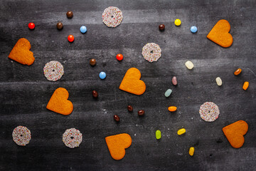 Various sweet food on black chalkboard background. Flat lay. Top view. Food concept.
