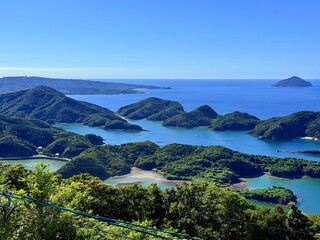 Scenic view from Jodake Observatory, Fukue Island, Goto Islands, Nagasaki, Japan – terraced farmland, island-dotted coastlines, and rich green hills with blue sky and sea.