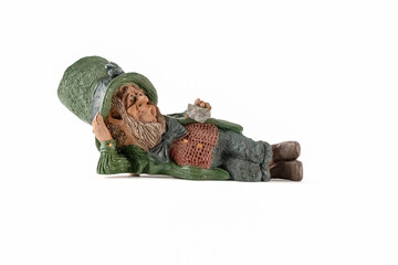 Vintage porcelain period figures of irish  farmer leprechaun in a prone position solated on white...
