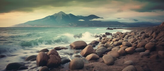 Group of people on a summer vacation at the coast, watching the waves crash against the rocks at sunset