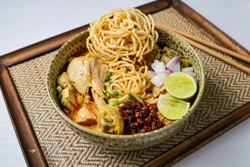 Northern thai curry Noodles with chicken on white background , Thai called  khao soi kai ,Northern food of thailand