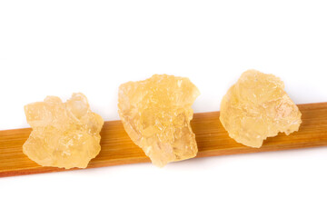 Handmade ancient yellow rock sugar from sugar cane, large grain pieces on bamboo tray
