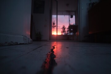 Sunset through apartment doorway, reflecting on floor