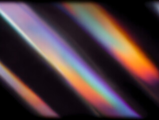 Rainbow light leak with prism like color bands sweeping across a moody black background offering atmospheric copy space for music covers social ads and event graphics