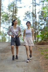 Fototapeta premium Asian Indonesian Women Walking on Forest Road in Yogyakarta