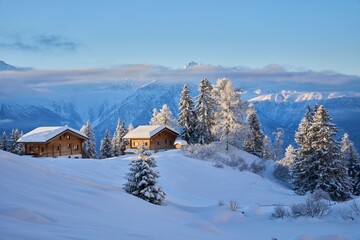 Snowy cabins in a winter mountain landscape, Valais Alps, Switzerland