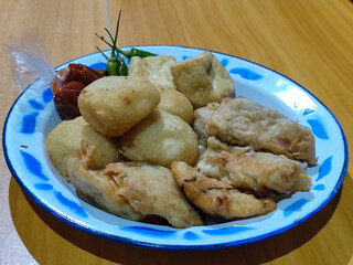 Gorengan, traditional Indonesian street food consisting of brontak tofu, fried banana, bakwan,...