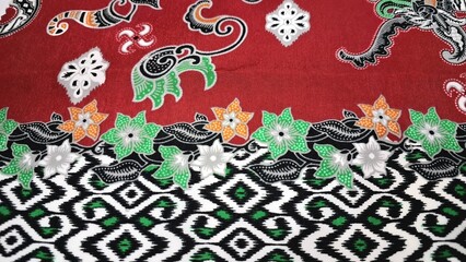 Traditional Black Batik Textile Pattern with White Ornamental Motifs Representing Indonesian...