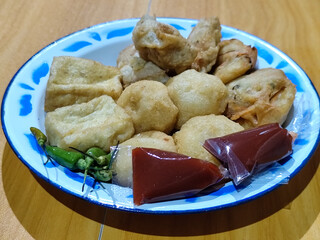 Gorengan, traditional Indonesian street food consisting of brontak tofu, fried banana, bakwan,...