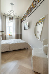 Modern Bright Bedroom with TV and Round Mirror
