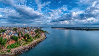Obraz premium Panoramic view of a city by a river under a dramatic sky