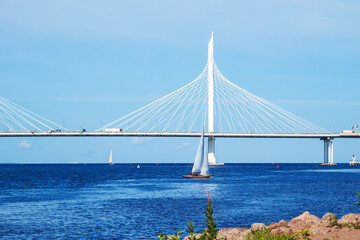 A lonely sailboat near the cable-stayed automobile bridge across the Gulf of Finland.