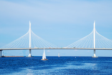 A lonely sailboat near the cable-stayed automobile bridge across the Gulf of Finland.