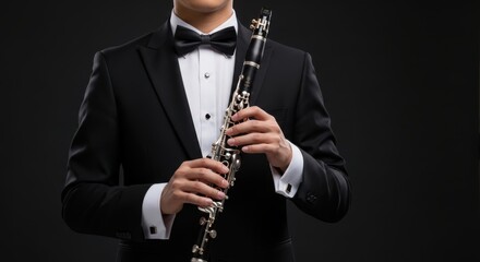 Sophisticated musician holding a clarinet ready for an orchestra performance or classical music concert with a formal appearance
