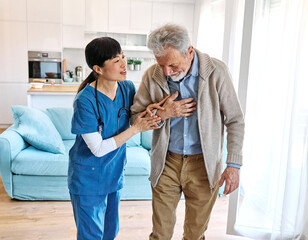 Doctor or nurse caregiver helping senior man walking  at home or nursing home