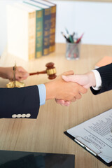 Legal Partnership. Close-up of a handshake between two lawyers in a law office.