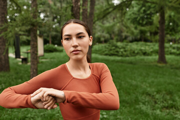 Inspired yoga teacher demonstrating strength and focus in a serene outdoor park setting
