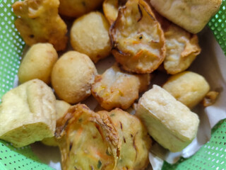 Gorengan, traditional Indonesian street food consisting of brontak tofu, fried banana, bakwan, jemblem, etc. Goes well with green chilies.