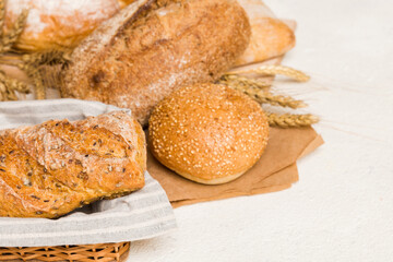 Homemade natural breads. Different kinds of fresh bread as background, perspective view with copy space