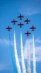Red jets in a formation with colored smoke trails