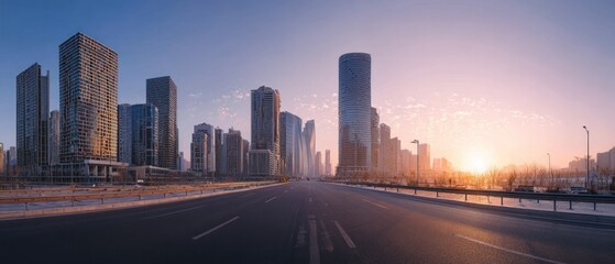 Fototapeta premium Sunrise Cityscape: Modern Skyline and Empty Road