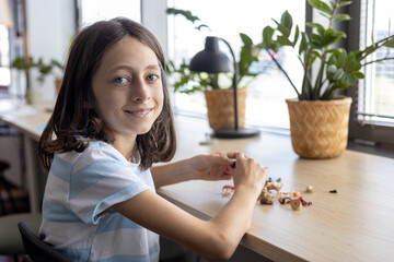 Young student assembling parts of educational project, learning through creative activity and...
