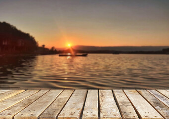 Wooden table top on the beach or sea.Party on the beach  sunset time concept.For montage product display or design key visual layout.View of copy space.
