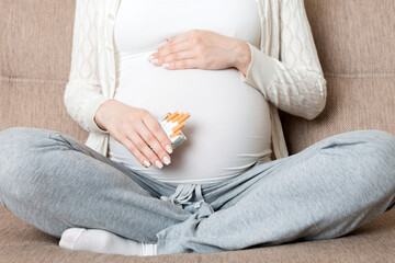 Pregnant woman with cigarette at home. mother smoking concept