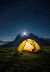 Illuminated tent under starry sky at night in the mountains scenery