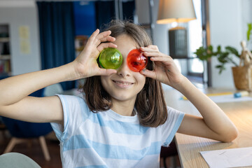 Joyful student posing with two bright red geometric shapes, expressing fun and creativity as part...