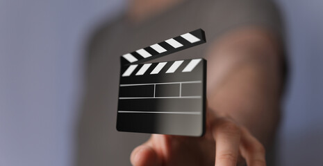 Person holding a digital clapperboard.  Perfect for film, video, production concepts.