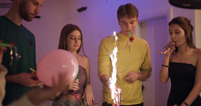 Friends Celebrate a Birthday with Sparklers, Noisemakers, and Festive Decorations at a Joyful Party Gathering