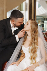 happy bride and groom in the lobby of the hotel on the day of the wedding