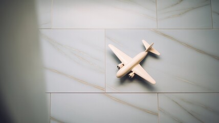 Miniature airplane on light blue tiled surface symbolizing global connection