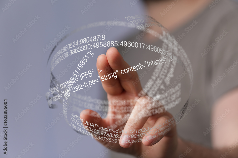 Poster person interacts with a futuristic holographic display showing code.