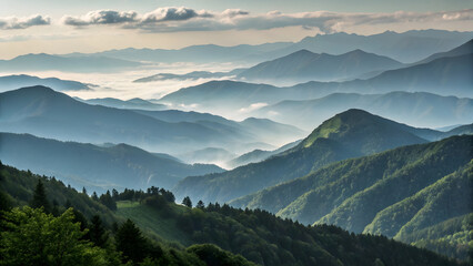 Misty mountain range with layered peaks shrouded in soft atmospheric haze at sunrise