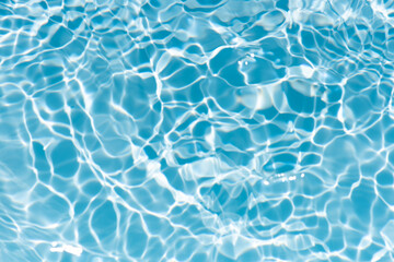 Blue water with ripples on the surface. Defocus blurred transparent blue colored clear calm water...
