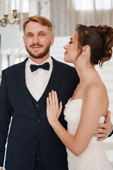 Portrait of a beautiful groom and a bride. Wedding ceremony.