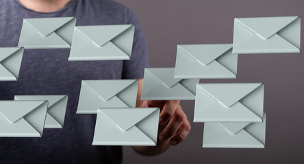 Person digitally managing many emails.  Concept of inbox overload, email management.