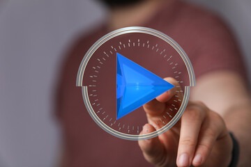 Close-up of a hand interacting with a digital play button interface.