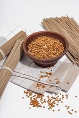 Japanese buckwheat soba noodles. Classic ingredient for preparing traditional dishes. Ceramic bowl