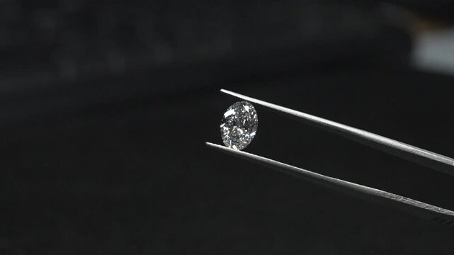diamond with tweezers closeup micro view in diamond manufactiring unit 