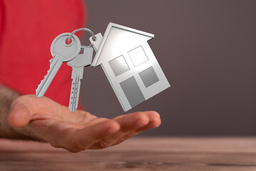 Image of house keys on an open hand, symbolizing home ownership, real estate, and new beginnings.