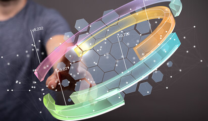 Abstract image of a person interacting with a holographic data display showing graphs and charts.