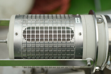 Precision-engineered industrial filtration device featuring a cylindrical metal mesh grid housing, designed for capturing larger river particles in water treatment or environmental monitoring applicat