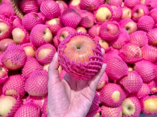 Red apples hold by women hand
