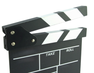 A black and white clapperboard used in filmmaking, featuring sections to denote takes and rolls.