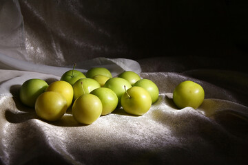 Fruit still life with yellow unripe plums